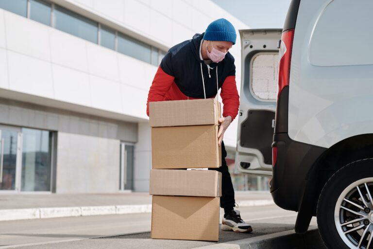 Urgent document courier, loading van with boxes