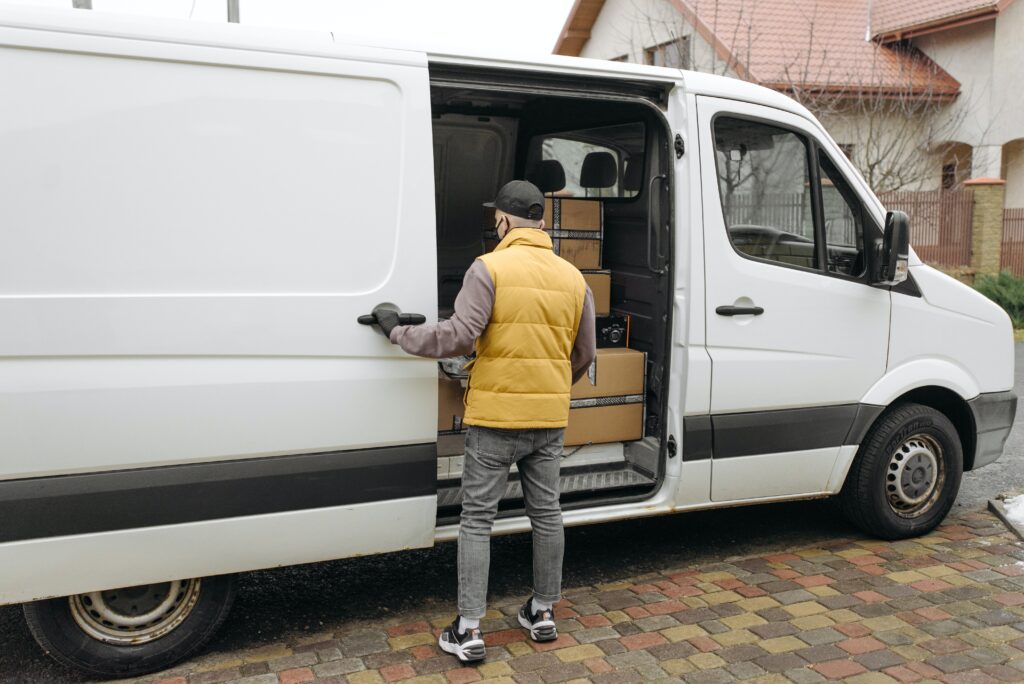 Same day courier service London, courier driver opening van with parcels